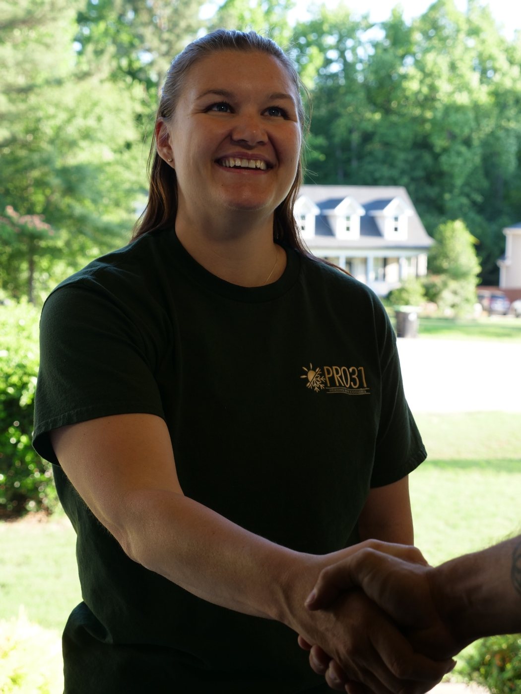 Rachelle Martins shaking hands with a customer at their front door
