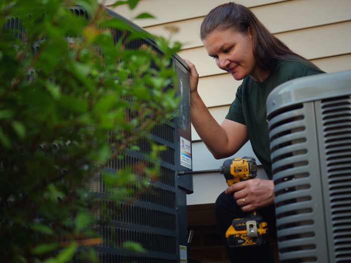 Rachelle making a repair on an outdoor condenser
